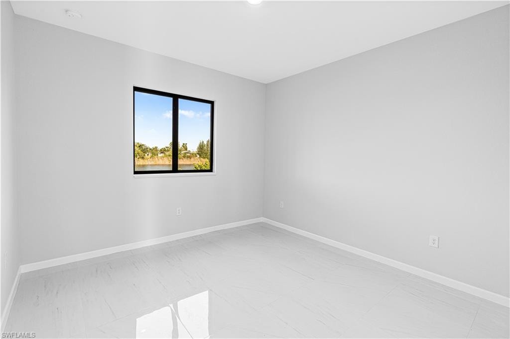 Empty room featuring baseboards