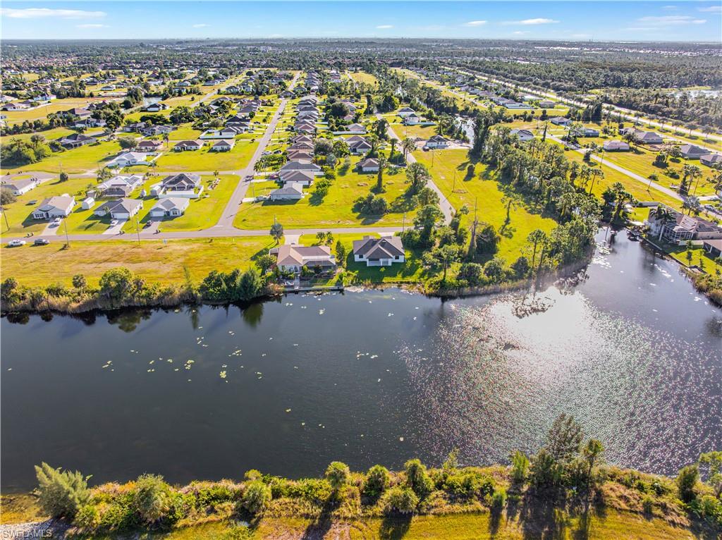 Aerial perspective of suburban area with a nearby body of water
