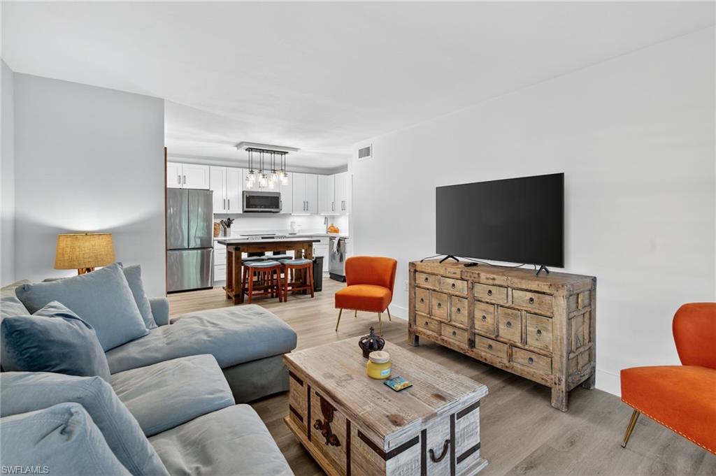 Living area with light wood finished floors and baseboards