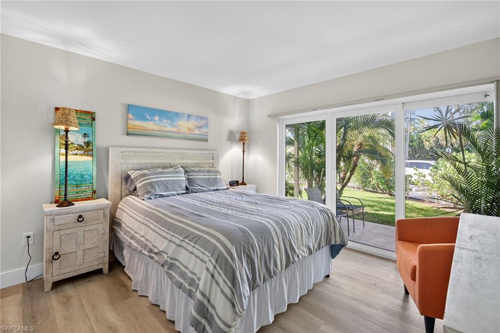 Bedroom with wood finished floors and access to exterior