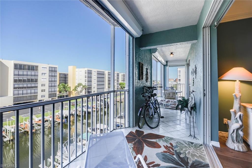 Balcony with a sunroom and a water view