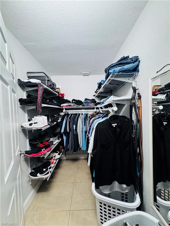 Spacious closet featuring light tile patterned floors