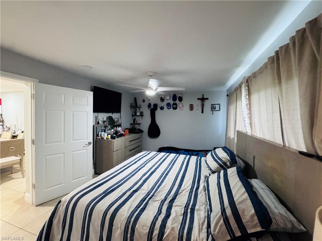 Bedroom featuring light tile patterned flooring and a ceiling fan