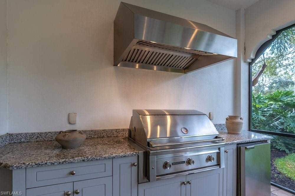 lanai with summer kitchen, grill, and beverage cooler