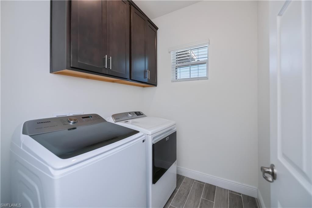 Laundry area featuring cabinet space, and washing machine and clothes dryer