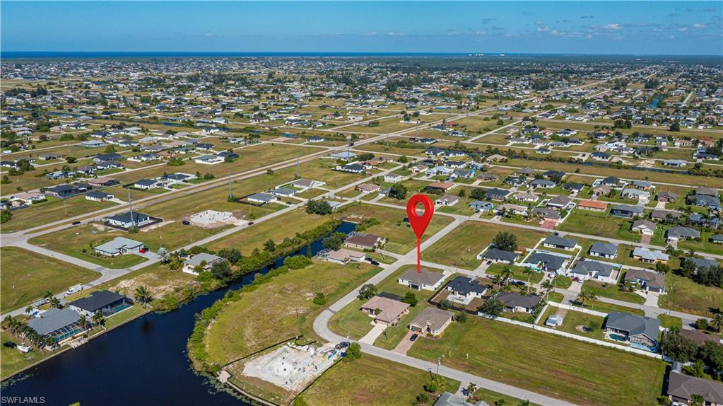 Aerial overview of property's location with nearby suburban area and a nearby body of water