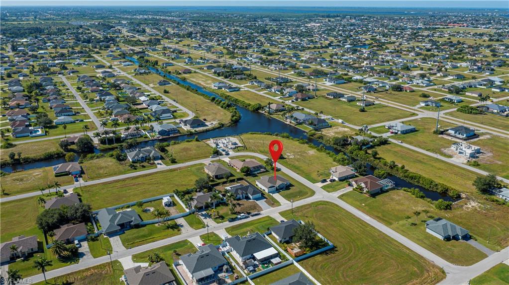 Aerial overview of property's location with nearby suburban area and a nearby body of water