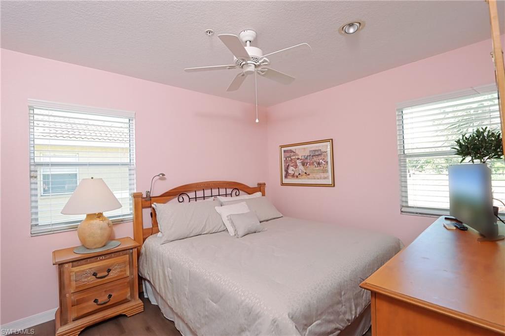 Bedroom with dark wood-type flooring and ceiling fan
