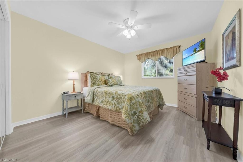 Bedroom with light wood finished floors and ceiling fan