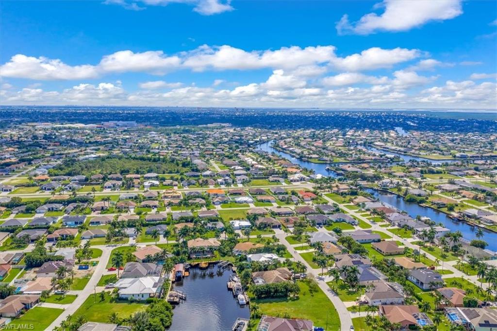 Aerial overview of property's location featuring nearby suburban area and a nearby body of water