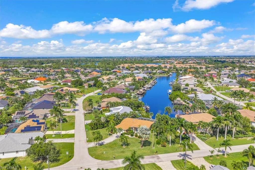Aerial view of property's location featuring nearby suburban area and a large body of water