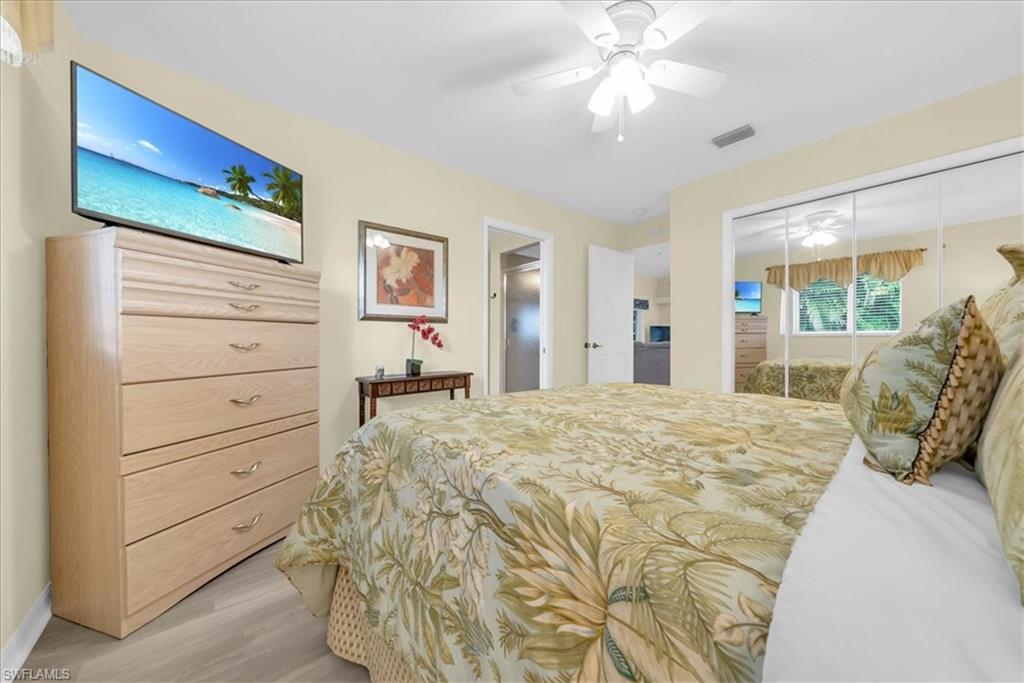 Bedroom featuring a closet, light wood-style flooring, and a ceiling fan