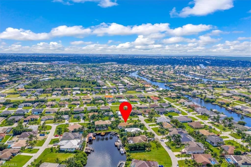 Aerial overview of property's location featuring nearby suburban area and a nearby body of water