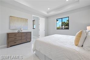 Bedroom featuring a raised ceiling and recessed lighting