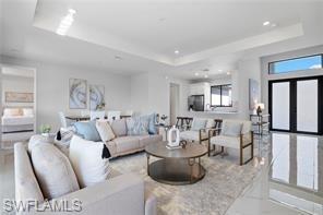 Living room featuring a raised ceiling and recessed lighting