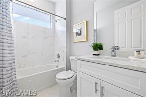 Full bathroom featuring vanity and shower / bath combination with curtain