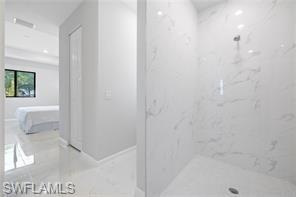 Bathroom featuring a marble finish shower