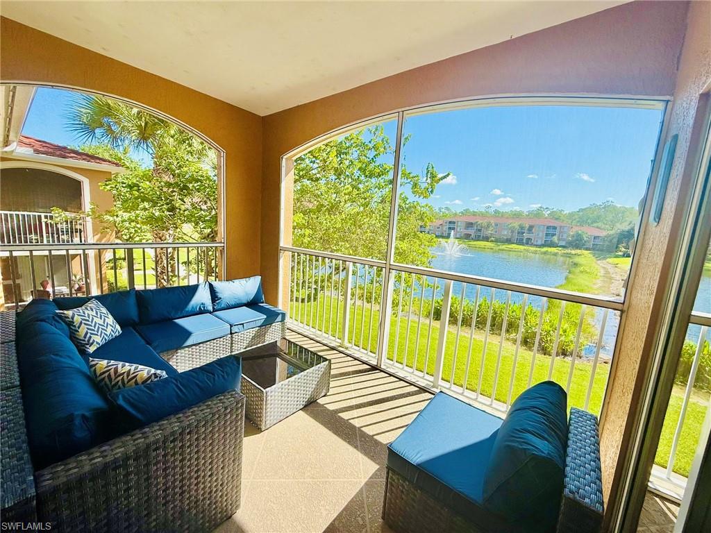 Balcony with a sunroom, a water view, and an outdoor living space