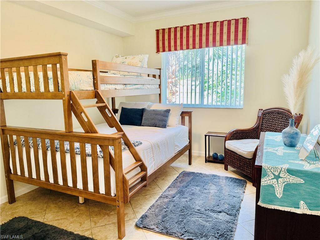 Tiled bedroom featuring ornamental molding