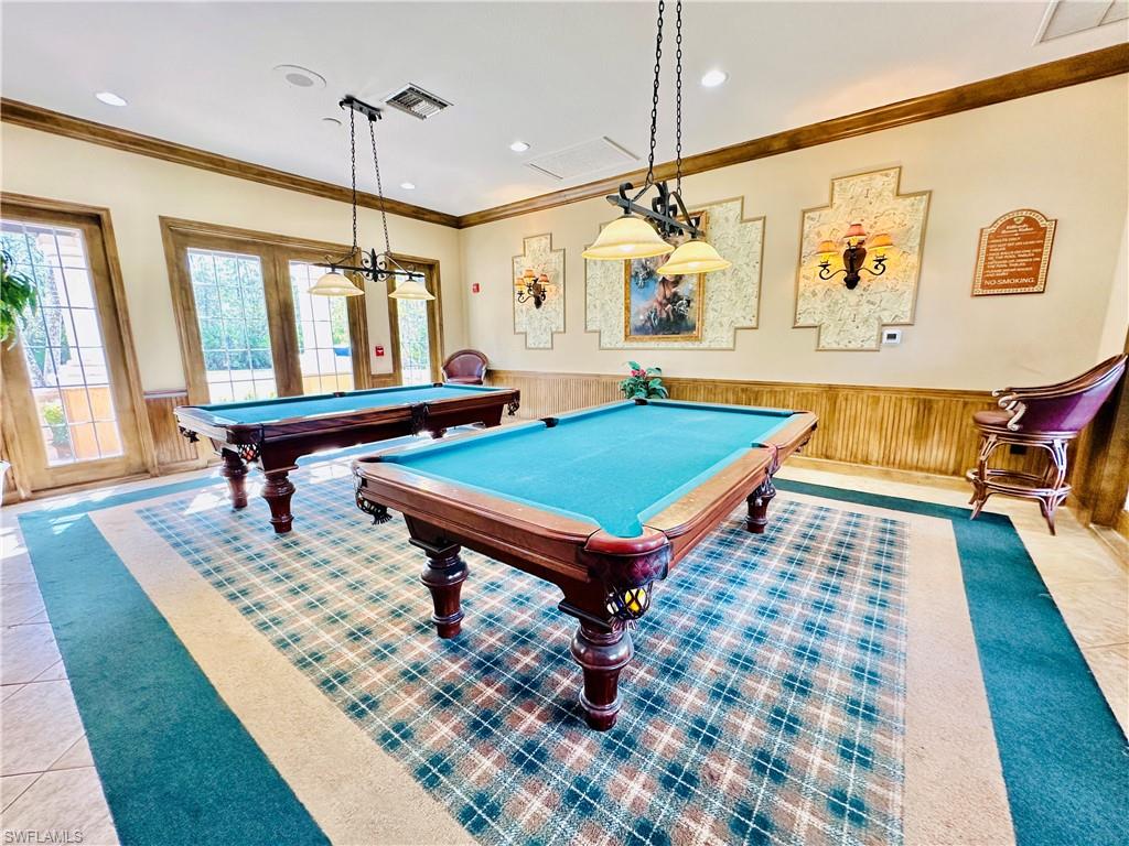Recreation room with wainscoting, wooden walls, crown molding, and billiards