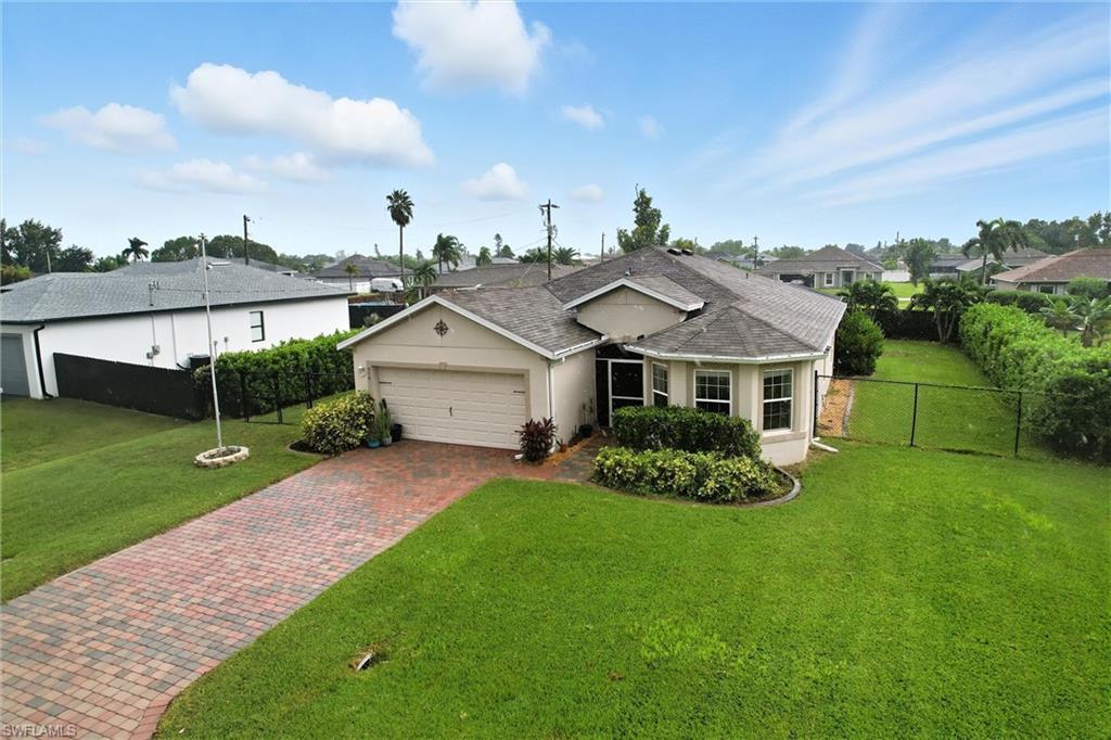 Ranch-style home featuring stucco siding, decorative driveway, roof with shingles, and an attached garage