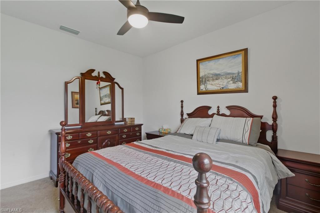 Bedroom featuring light carpet and ceiling fan