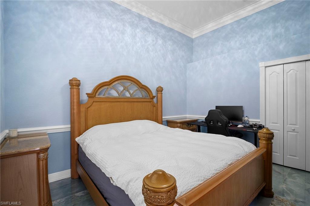 Bedroom with a closet and ornamental molding