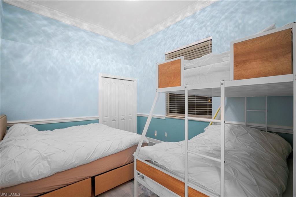 Bedroom with a closet and crown molding