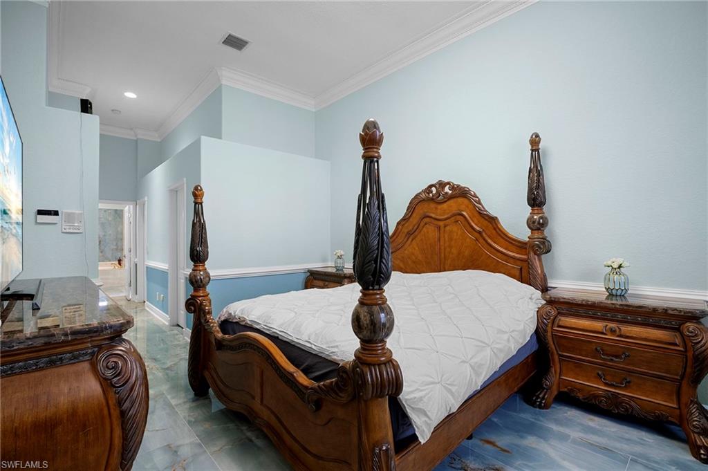 Bedroom featuring crown molding and recessed lighting