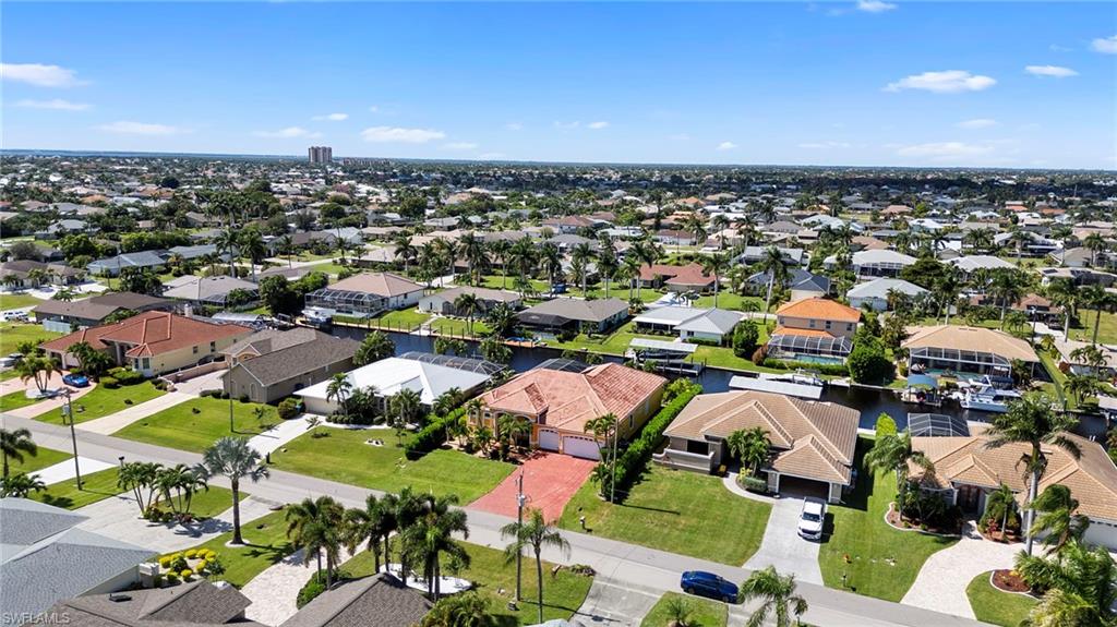 Aerial perspective of suburban area with a nearby body of water