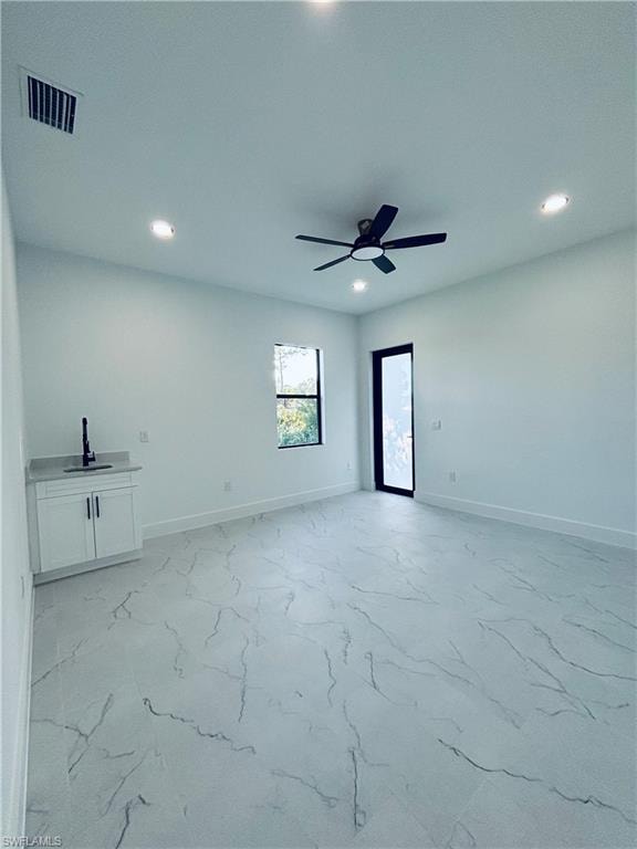 Unfurnished living room with light marble finish flooring and recessed lighting