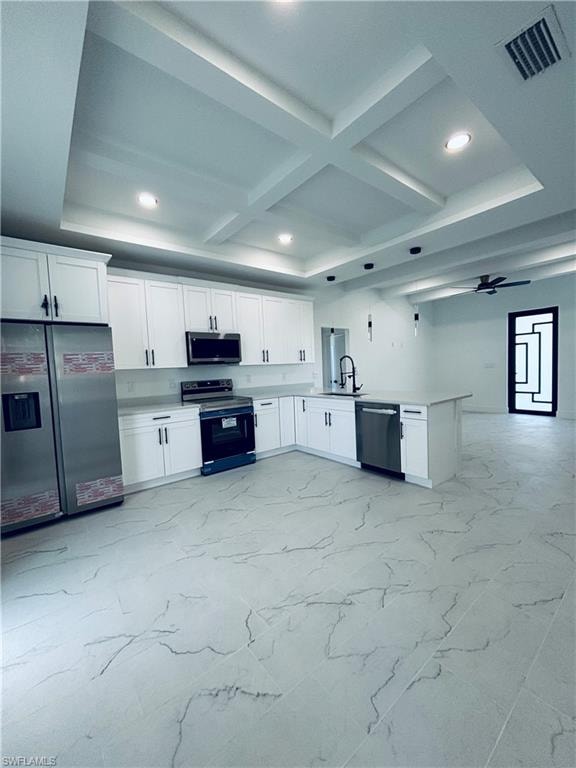 Kitchen featuring white cabinetry, stainless steel appliances, coffered ceiling, beam ceiling, and light marble finish flooring
