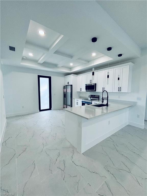 Kitchen featuring beamed ceiling, a peninsula, coffered ceiling, white cabinets, and appliances with stainless steel finishes