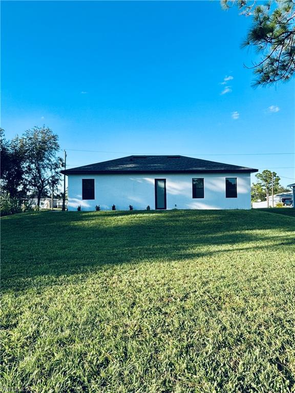 View of property exterior with a lawn