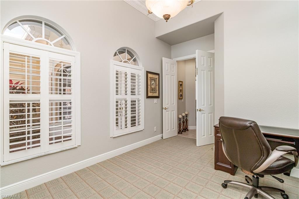 Office space featuring light carpet and crown molding