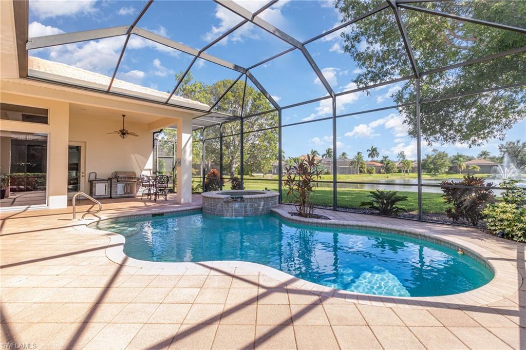 View of pool featuring a sunroom, a lanai, a water view, and a patio area