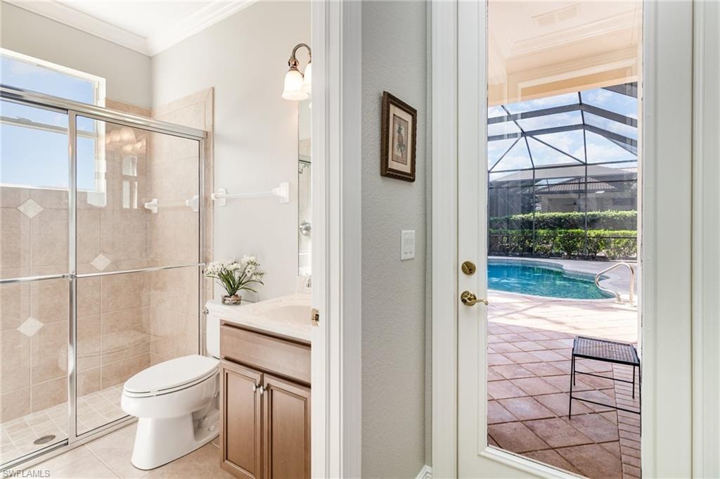 Bathroom with ornamental molding, vanity, a shower stall, and light tile patterned flooring