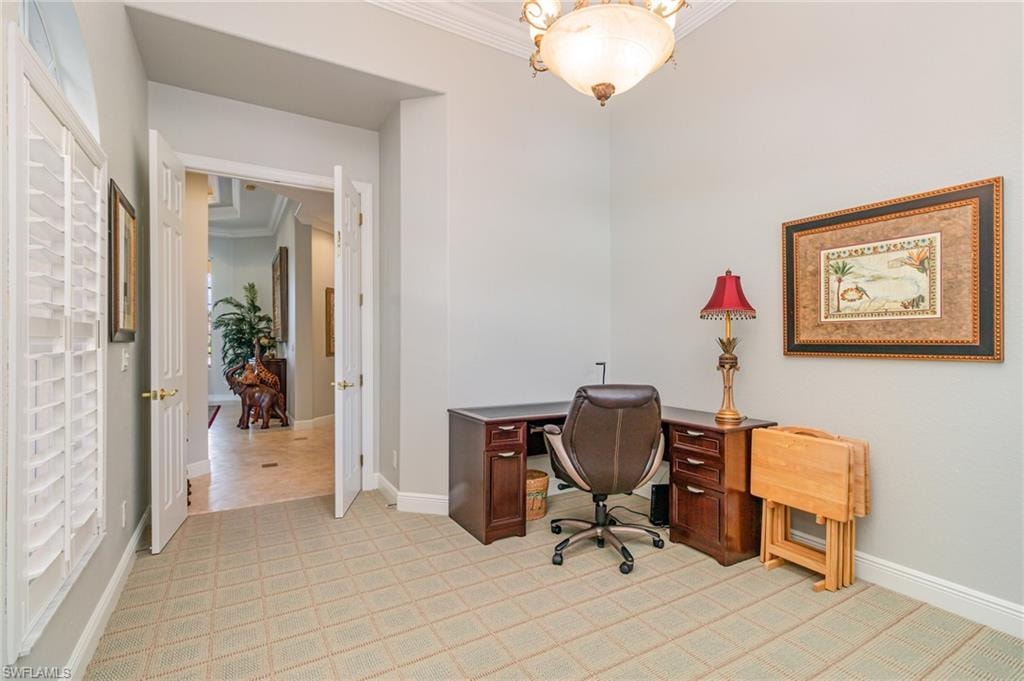 Office with crown molding and light colored carpet