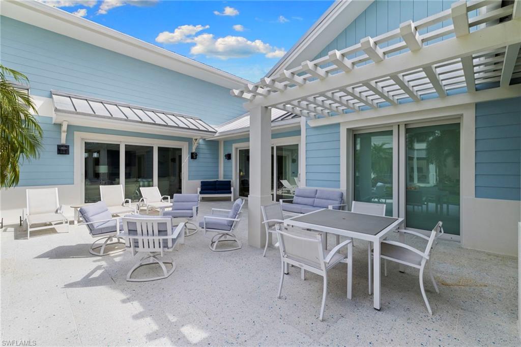 View of patio with outdoor dining space, an outdoor living space, and a pergola