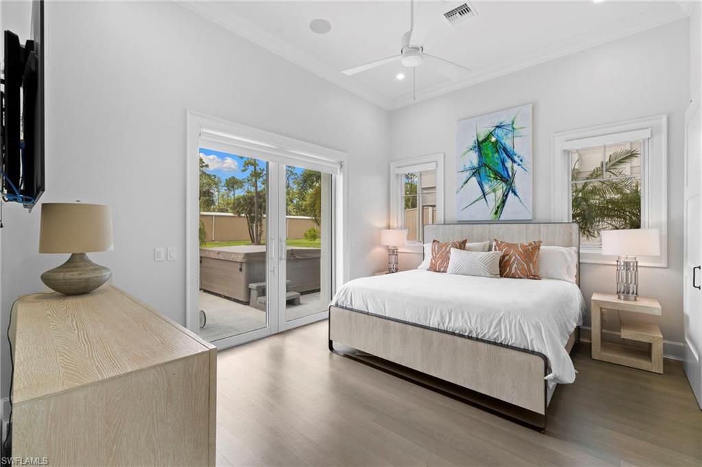 Bedroom featuring ornamental molding, wood finished floors, access to exterior, a ceiling fan, and recessed lighting