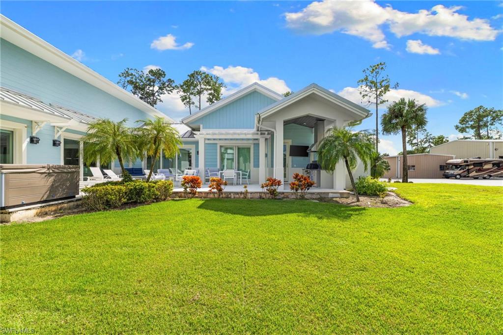 Back of property featuring a lawn and a patio area