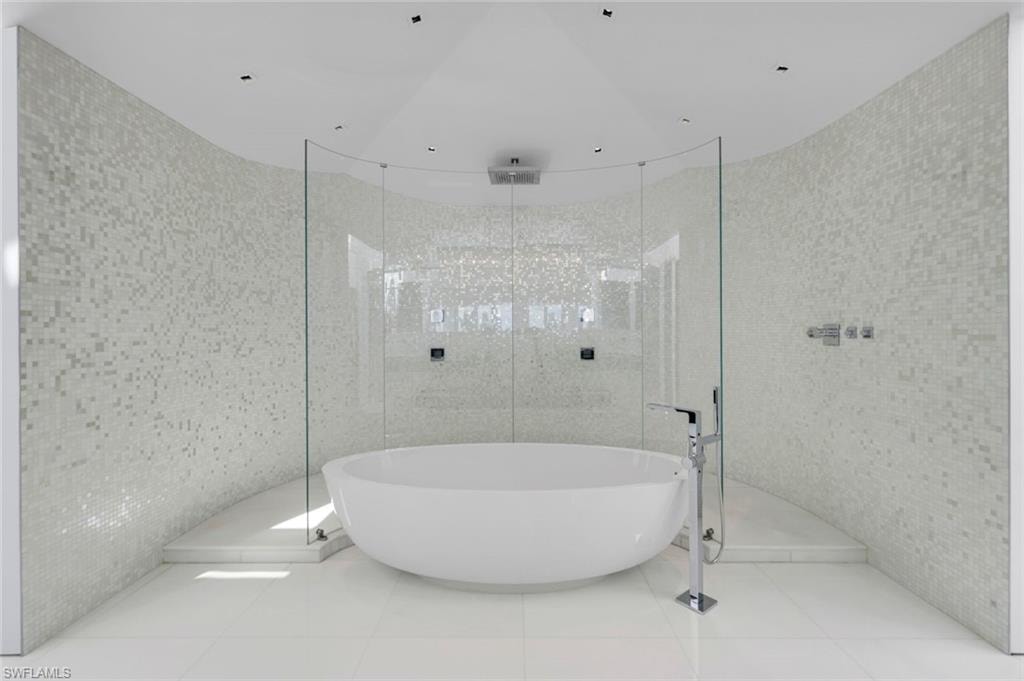 Spa-style bathroom with Bisazza mosaic tile, Dornbracht fixtures, Thassos marble floors, and glass shower.