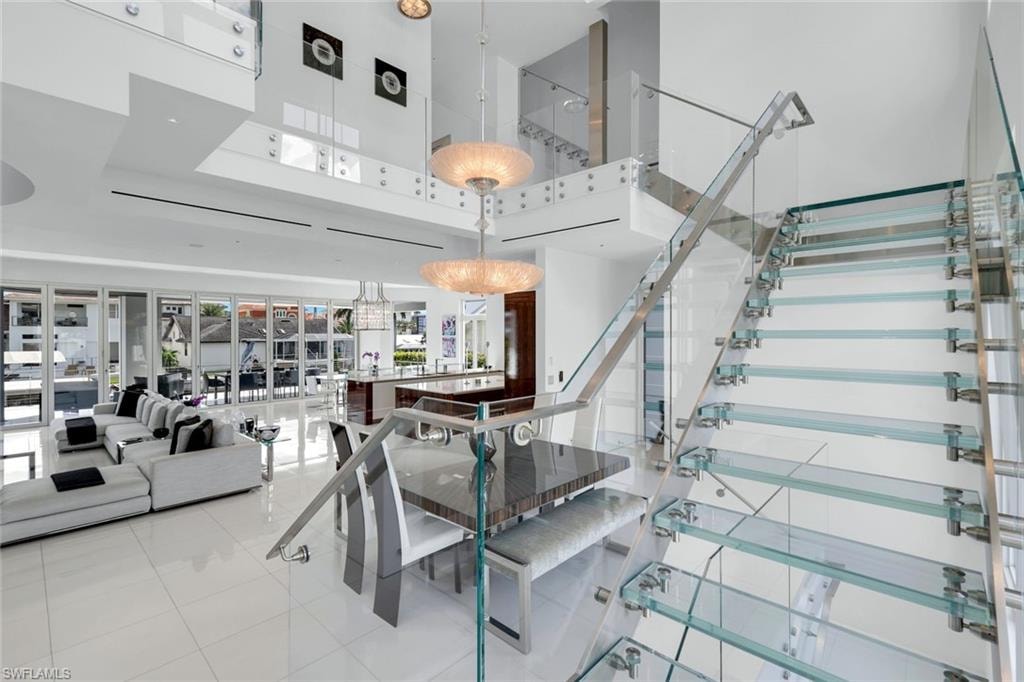 Custom glass staircase with stainless-steel accents, showcasing sleek modern craftsmanship