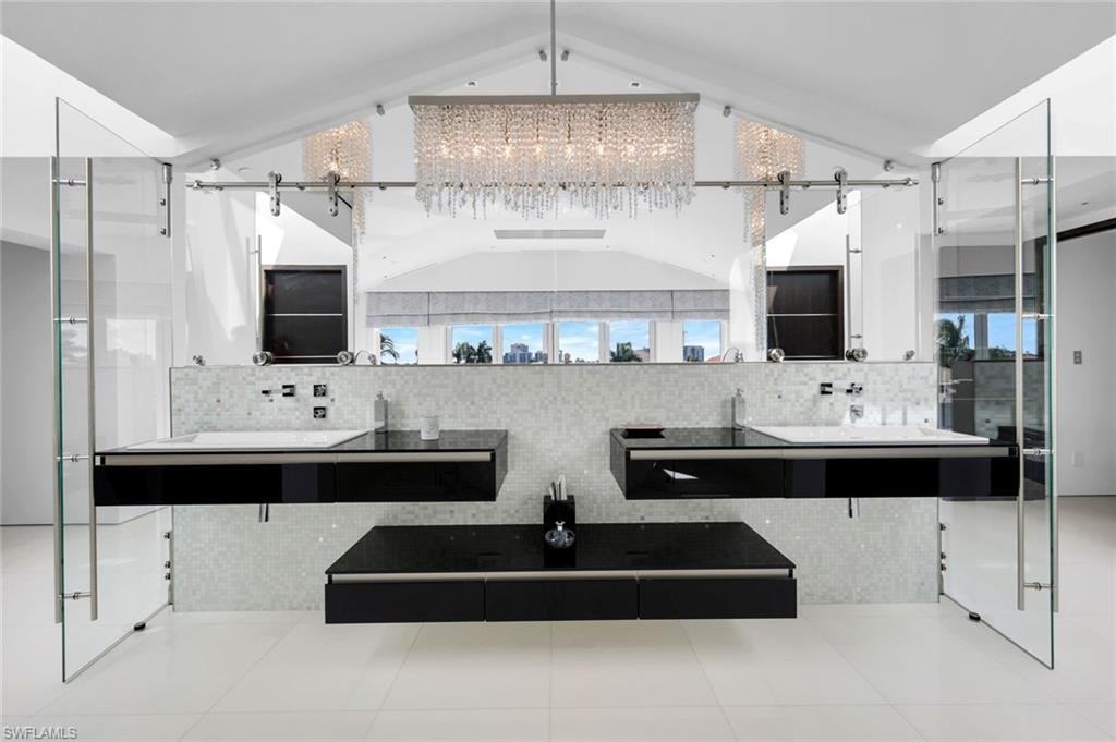 Master bathroom featuring custom cabinetry, Bisazza mosaic tile, Dornbracht fixtures, and Swarovski lighting.
