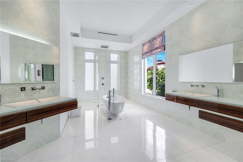 Spa-like bathroom with Allmilmo cabinetry, Bisazza mosaic tile, Dornbracht fixtures, and Thassos marble floors.