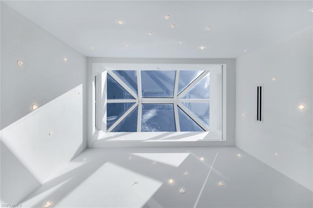 Architectural skylight with custom recessed lighting, flooding the space with natural light.