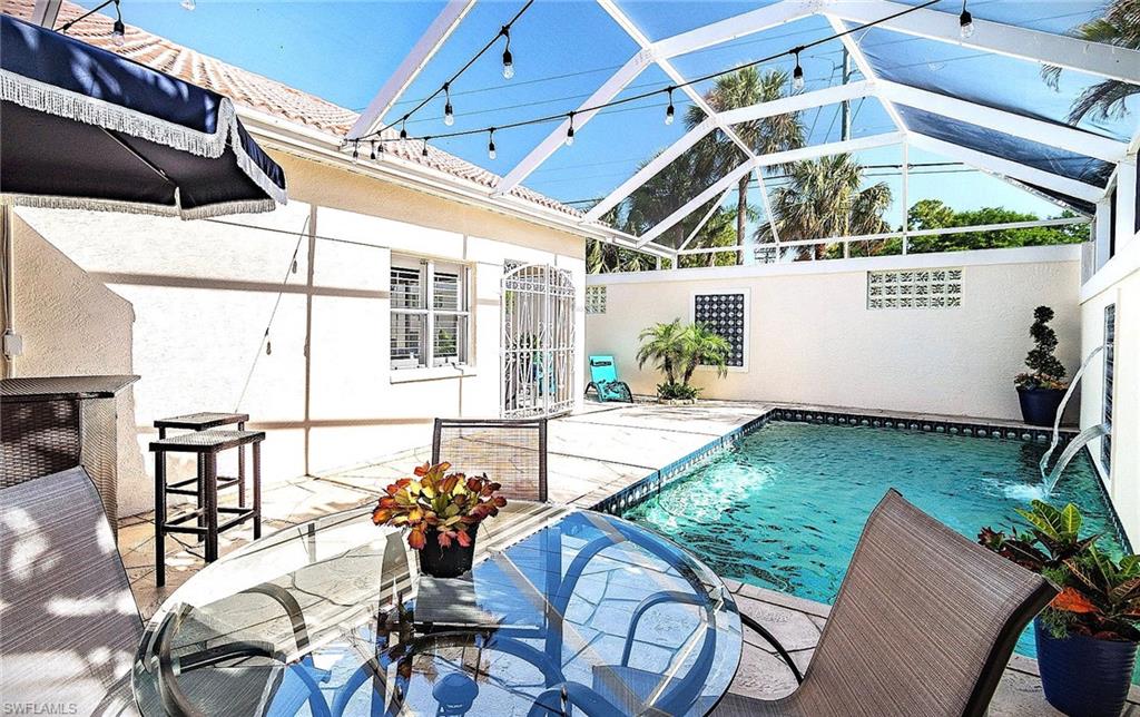 Swimming pool with a sunroom, a patio, and a lanai
