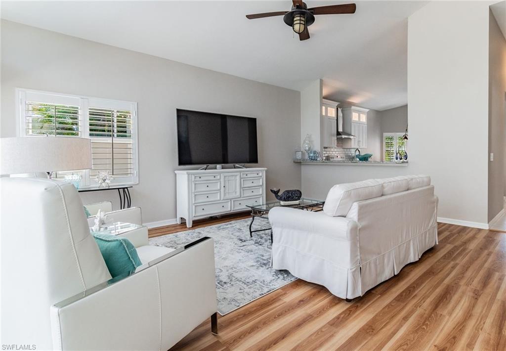 Living area featuring wood finished floors and a ceiling fan