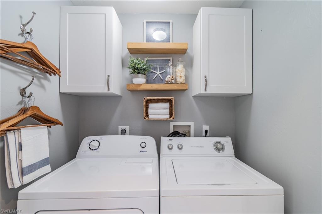 Laundry room featuring cabinet space and washing machine and clothes dryer