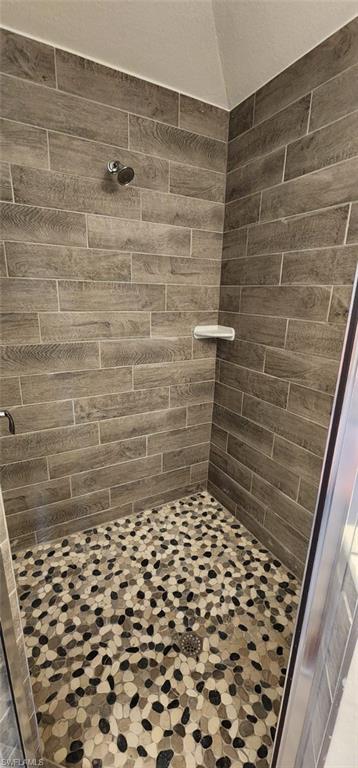 Full bath featuring a shower stall